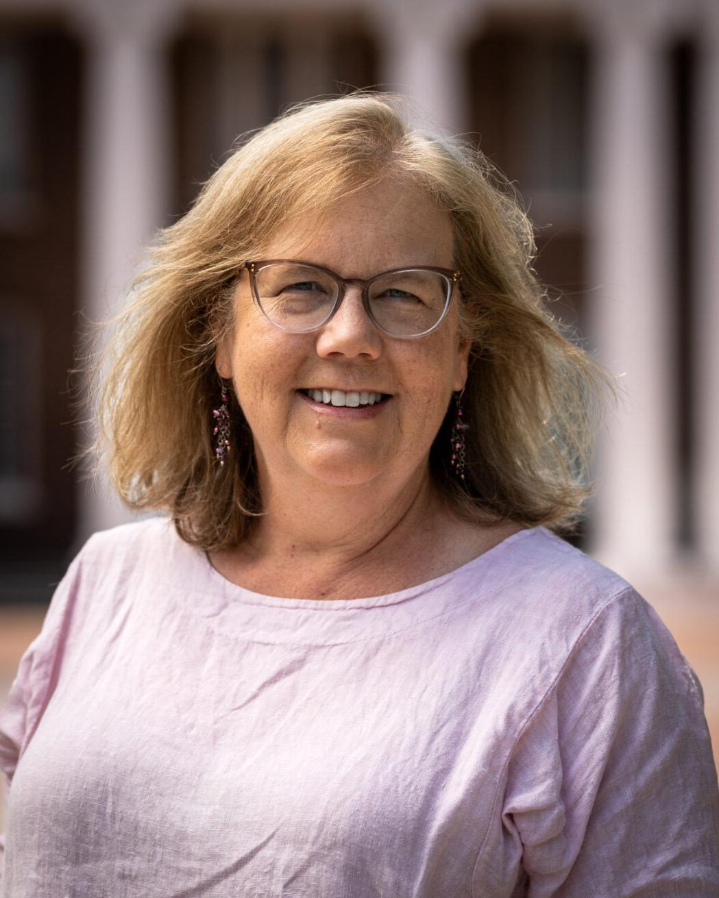 Dr. Margaret Godbey poses in front of Davidson Hall on Coker's campus.